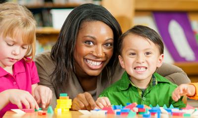 Teacher in the classroom with young children.